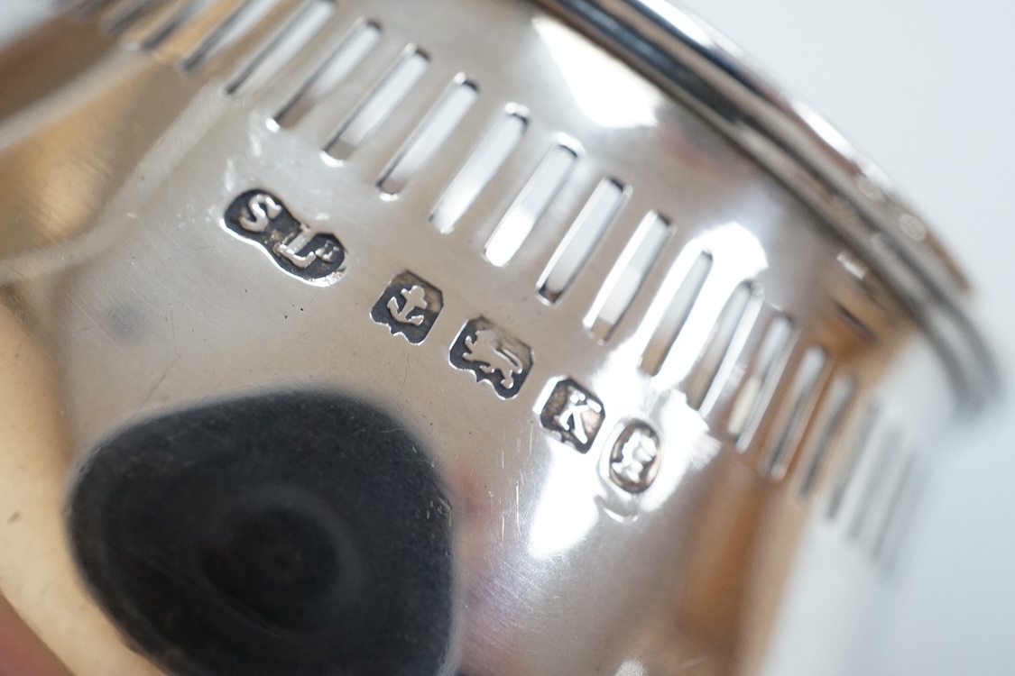Four assorted silver condiments including a Victorian bun salt and a late Victorian pepper mill, together with a small silver bowl, a silver matchbox sleeve and a small silver two handled cup.